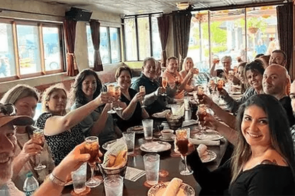 A group of people sitting at a table with drinks.