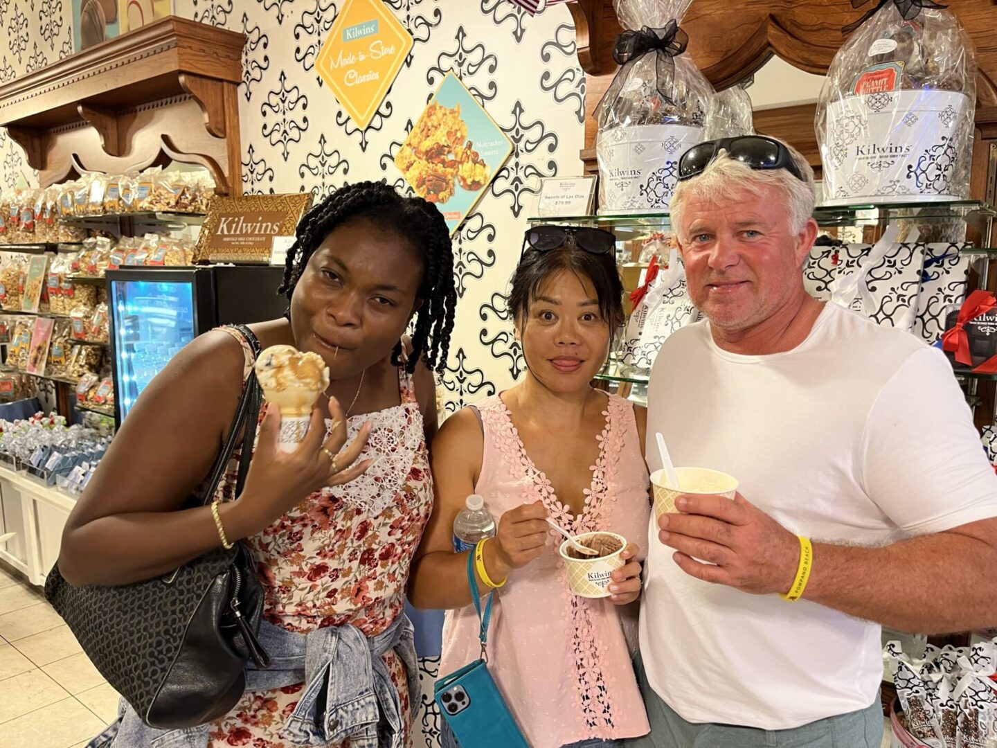 A Man With two Women With Gelato Cups in Hand