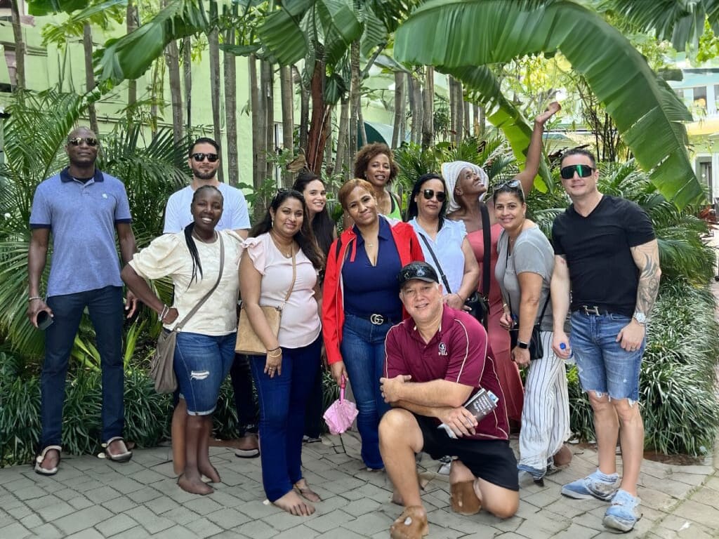 Group of friends smiling in tropical garden.