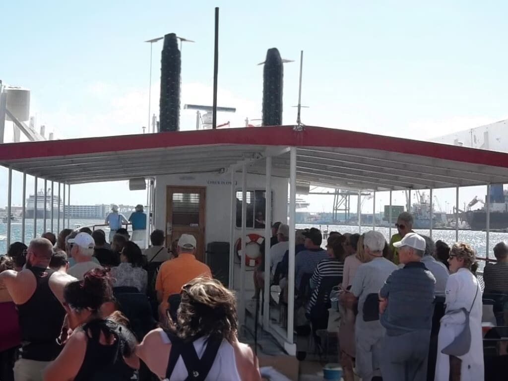 Passengers on a ferry boat with a view of the harbor.