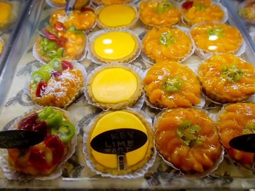 Assortment of fruit tarts in display case.