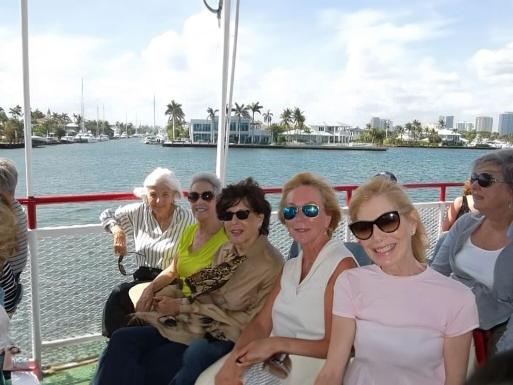 Five women in sunglasses on a boat.